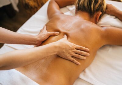 a-person-massaging-a-clients-bare-back