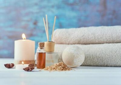towels-candle-and-massage-oil-on-white-table-photo